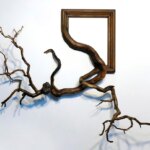 Tree roots and branches fused with ornate picture frames by Darryl Cox