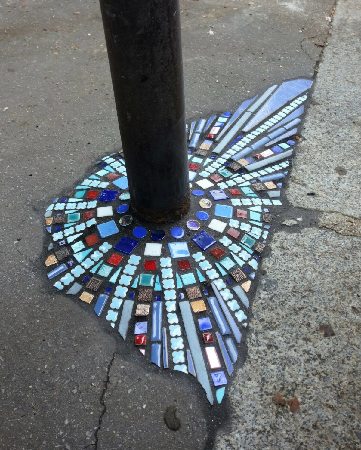 Fractured sidewalks, pavements, and walls repaired with vibrant tiled mosaics by Ememem