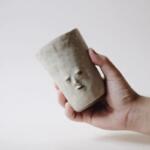 Emotive little faces emerging from minimalist ceramics by Fan Yanting